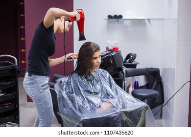 Professional hairdresser, stylist drying client hair with blow-dryer at salon, studio. Beauty and haircare concept - Powered by Shutterstock