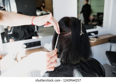 Professional Hairdresser Working With Client's Hair In Salon. Pulling A Strand