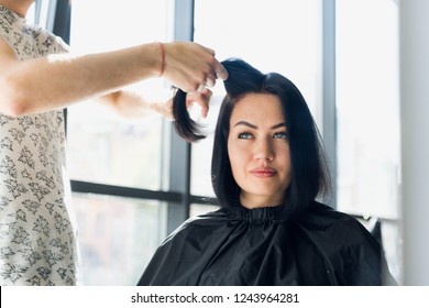 Professional Hairdresser Working With Client's Hair In Salon. Pulling A Strand