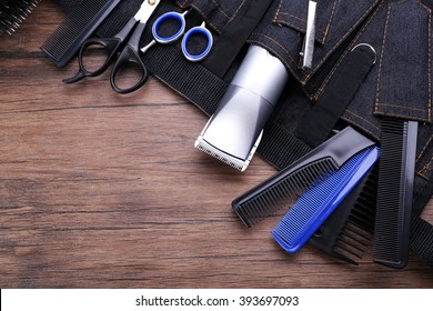 Professional Hairdressing Equipment In Black Case On Wooden Table Background