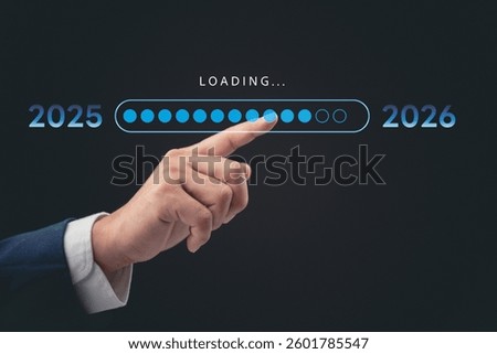 A professional hand interacting with a digital loading bar, marking the transition from 2025 to 2026. The concept represents progress, time, and future planning in business and technology.