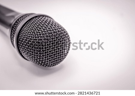 Professional handheld dynamic microphone isolated on white background, ideal for music, broadcasting, podcast, speech, and audio production.