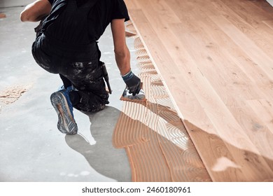 Professional handyman installing laminate flooring in a new apartment. - Powered by Shutterstock