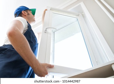 Professional handyman installing window at home. - Shutterstock ID 1014442987