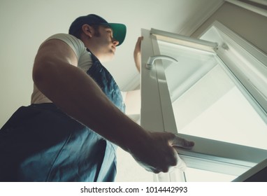 Professional Handyman Installing Window At Home.