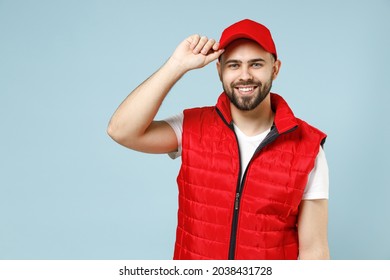 Professional Happy Delivery Guy Employee Man In White T-shirt Vest Uniform Workwear Work As Dealer Courier Hold Touch Red Cap Isolated On Pastel Blue Color Background Studio Portrait. Service Concept