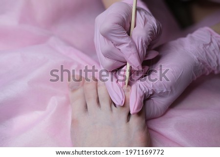  Professional hardware pedicure on an electric machine. Peeling of feet with a special electrical device. Foot care in the SPA salon.