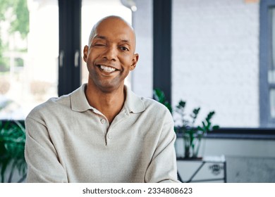 professional headshots, cheerful dark skinned man with myasthenia gravis disease looking at camera, happy office worker with eye syndrome, inclusion and diversity