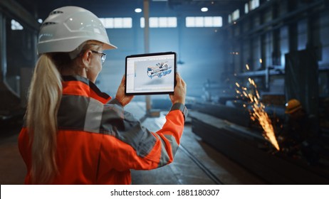 Professional Heavy Industry Engineer Uses Tablet Computer For Augmented Reality Render With Interactive Turbine Engine Blueprint. Female Industrial Specialist Working In A Metal Manufacture Warehouse.