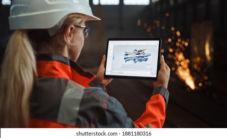 Professional Heavy Industry Engineer Uses Tablet Computer for Augmented Reality Render with Interactive Turbine Engine Blueprint. Female Industrial Specialist Working in a Metal Manufacture Warehouse.