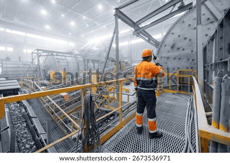 Professional heavy industry engineer worker control industrial ball mill grinds ore at mining and concentrating plant. Metal manufacture factory concentrate of copper and gold.