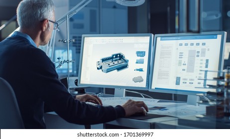 Professional Heavy Industry Engineer Works On Computer Uses CAD Software With Integrated Development Environment To Design Industrial Machinery Component. Over The Shoulder Shot