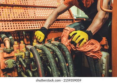 Professional Heavy Machinery Mechanic Performing Pneumatic System Maintenance In An Excavator. 