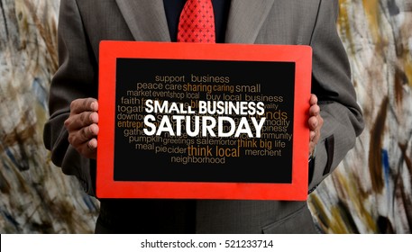 Professional Holding Small Business Saturday Sign In Hand