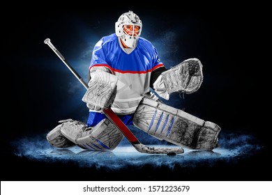 Professional ice hockey goalkeeper or goalie or goaltender isolated on black backgroung