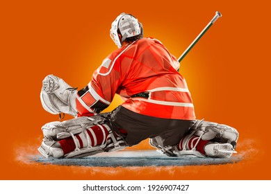 Professional Ice Hockey Goalkeeper Or Goalie Or Goaltender Isolated On Orange Backgroung