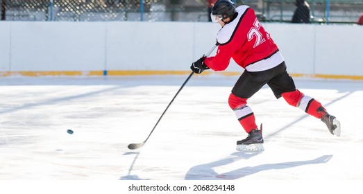 Professional ice hockey player in attack on the rink. Image with copy space