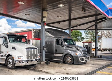 Professional Industrial Standard Big Rig Semi Trucks Tractors With Different Loaded Semi Trailers Refills The Semi Trucks Tanks With Diesel At Truck Stop Gas Station To Continue The Cargo Freights