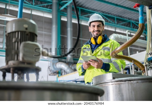 professional\
inspection control scientist in uniform are working for fruit juice\
production industry in food manufacturing factory, water drink\
checking and beverage research in\
laboratory