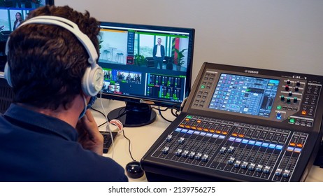 Professional instrumental sound engineer in a TV studio or at a concert. Video production. Record. Close-up music digital mixer for stage setup. Video recording. Video camera. Paris France March 2022 