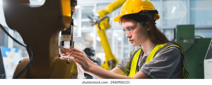 Professional and intelligence female engineer used her technical hard skill to fix, repair or maintenance machine robotic arm in factory or industrial, examining or welding automobile machine workshop - Powered by Shutterstock