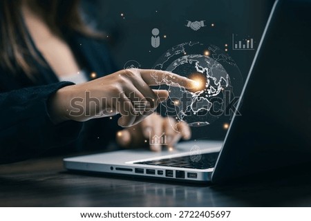 A professional interacting with a digital globe interface above a laptop, representing global business, online commerce, international connectivity, digital economy, and worldwide market expansion.
