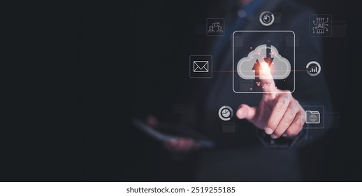 A professional interacts with digital cloud technology, showcasing innovation and connectivity in a modern work environment.