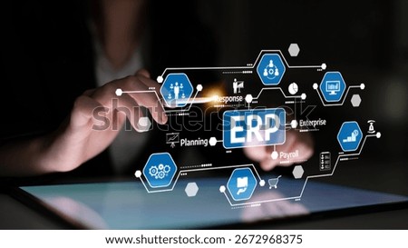 A professional interacts with a digital tablet showcasing an ERP system interface, highlighting key features like data management and enterprise solutions in a modern workspace. Tessel