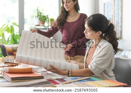 Professional interior designers and decorator checking different types of wallpaper, home renovation and creativity concept