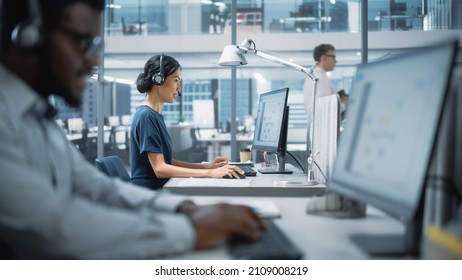 Professional Investment Traders Talking into Headset, Working on Computer with Screen Showing Finance Statistics, Charts Strategy, Stock Market, Telemarketing. Big Office Call Center. - Powered by Shutterstock