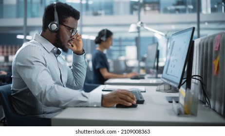 Professional Investment Traders Talking into Headset, Working on Computer with Screen Showing Finance Statistics, Charts Strategy, Stock Market, Telemarketing. Big Office Call Center.
