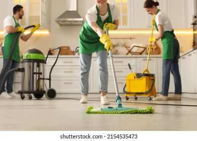 Professional janitors working in kitchen, closeup. Cleaning service - Powered by Shutterstock