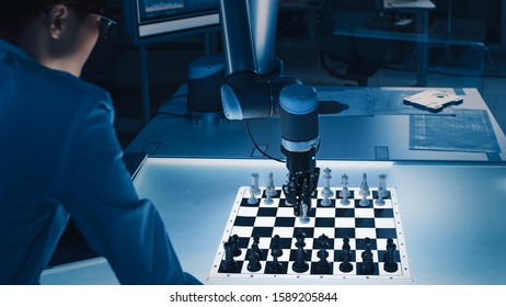 Professional Japanese Development Engineer is Testing an Artificial Intelligence Interface by Playing Chess with a Futuristic Robotic Arm. They are in a High Tech Modern Research Laboratory.