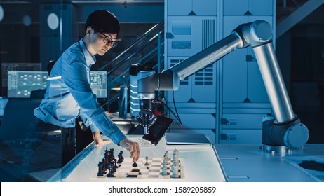 Professional Japanese Development Engineer is Testing an Artificial Intelligence Interface by Playing Chess with a Futuristic Robotic Arm. They are in a High Tech Modern Research Laboratory.