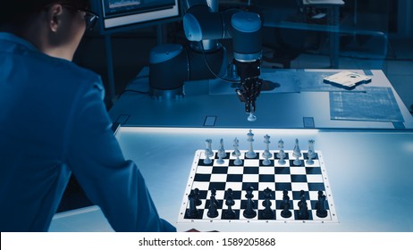Professional Japanese Development Engineer is Testing an Artificial Intelligence Interface by Playing Chess with a Futuristic Robotic Arm. They are in a High Tech Modern Research Laboratory.