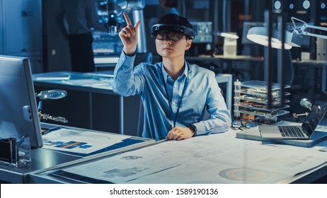 Professional Japanese Development Engineer is Working in a AR Headset, Making Gestures of Touching Virtual Graphics Pieces in the High Tech Research Laboratory with Modern Computer Equipment. - Powered by Shutterstock - Get 15% off with code: PIKWIZARD15