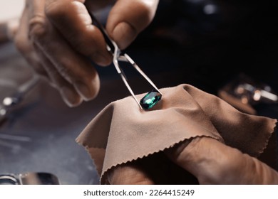 Professional jeweler working with gemstone, closeup view - Shutterstock ID 2264415249