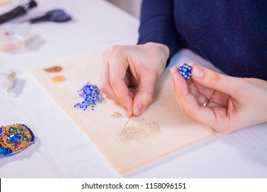 Professional jewelry designer making handmade eardrop with beads in studio, workshop. Fashion, creativity and handmade concept - Powered by Shutterstock