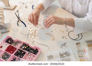 Professional jewelry designer making handmade jewelry in studio workshop close up. Fashion, creativity and handmade concept