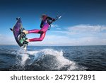 professional kiter performs a difficult trick on a beautiful background with splashes of water from the sea and a cloudy sky