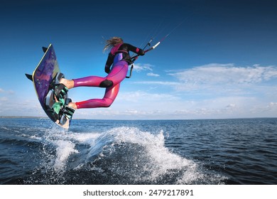 professional kiter performs a difficult trick on a beautiful background with splashes of water from the sea and a cloudy sky - Powered by Shutterstock