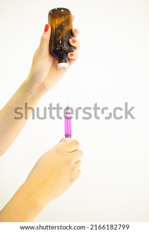 Professional laboratory technician preparing injection from amber vial on white background