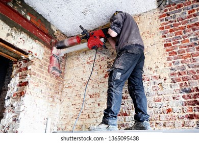 Professional Laborer Pierce A Big Round Hole In A Brick Wall