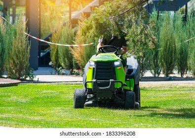 Professional lawn mower with gardener cutting the grass on a lawn - Shutterstock ID 1833396208