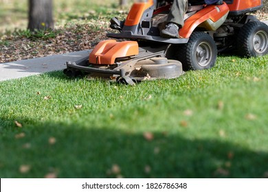 Professional Lawn Mowing Machine. Summer And Autumn Season Sunny Lawn Mow In The Garden