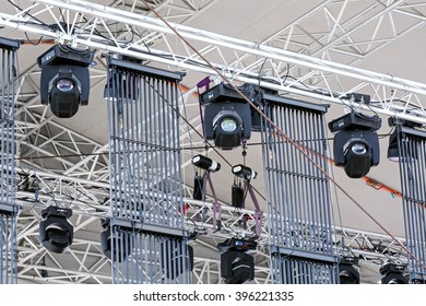 professional lighting equipment under roof of outdoor concert stage 