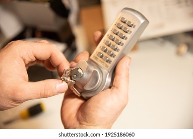 Professional Locksmith holding a Keypad lock