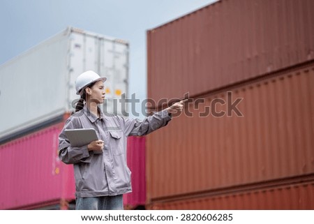 Professional logistics worker inspecting cargo containers at warehouse yard. Shipping, freight transport