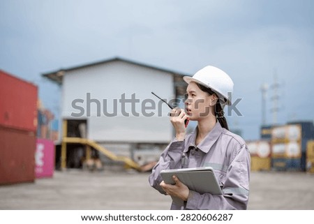 Professional logistics worker inspecting cargo containers at warehouse yard. Shipping, freight transport