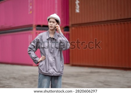 Professional logistics worker inspecting cargo containers at warehouse yard. Shipping, freight transport